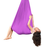 Kids Elastic Yoga Sensory Hammock Swing with a child sitting inside it.